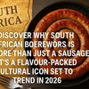 High-quality realistic photograph of traditional South African sausage boerewors coiled on a wooden board