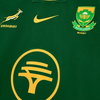 Close-up of 2025 Nike Springboks Home Stadium jersey in green with gold Springbok, Nike swoosh, SA Rugby crest, and FNB logo embroidery.