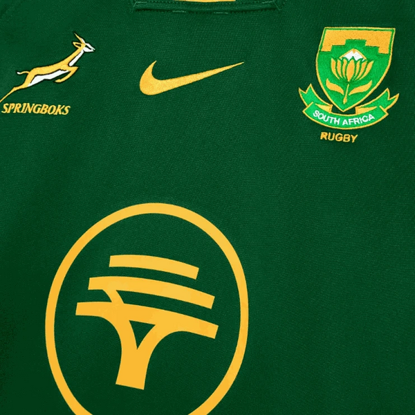 Close-up of 2025 Nike Springboks Home Stadium jersey in green with gold Springbok, Nike swoosh, SA Rugby crest, and FNB logo embroidery.