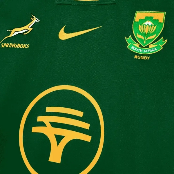 Close-up of 2025 Nike Springboks Home Stadium jersey in green with gold Springbok, Nike swoosh, SA Rugby crest, and FNB logo embroidery.