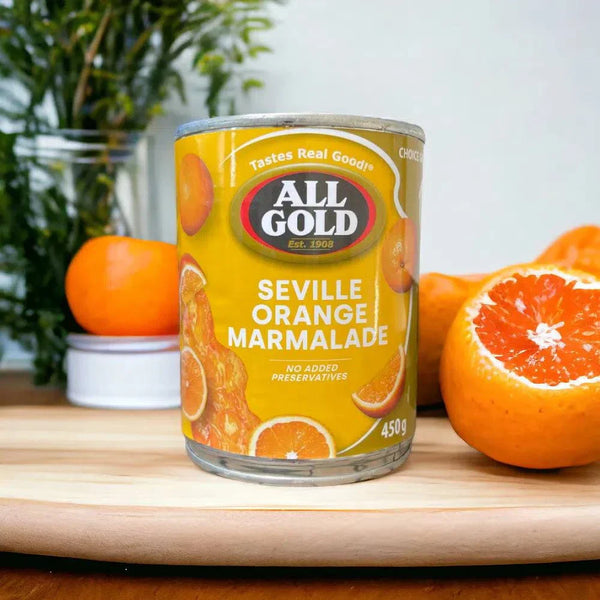 450g jar of South African All Gold Seville Orange Marmalade with oranges on cutting board