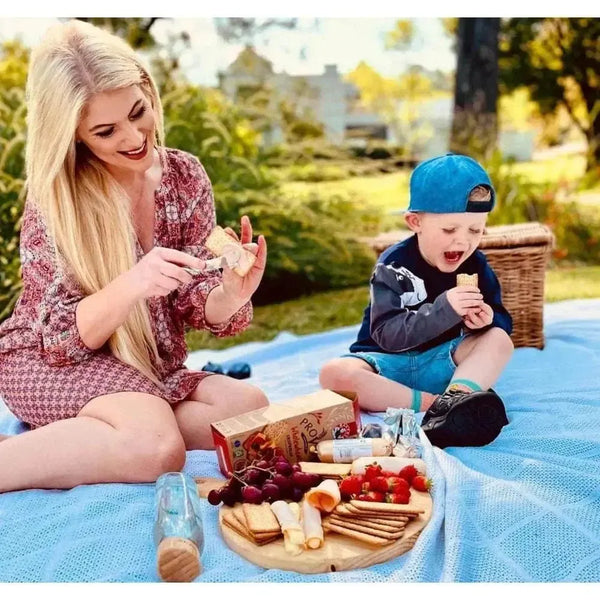 Bakers Provita biscuits - Wholewheat Crispbread 500g picnic scene with woman and child enjoying snacks outdoors.