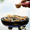 CADAC Carri Chef 50 versatile gas BBQ with dome, spacious cooking surface, grilling fish and vegetables outdoors.