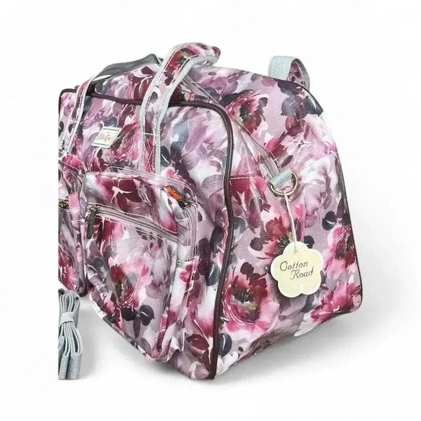 Light pink Cotton Road travel bag with purple rose print and spacious compartments