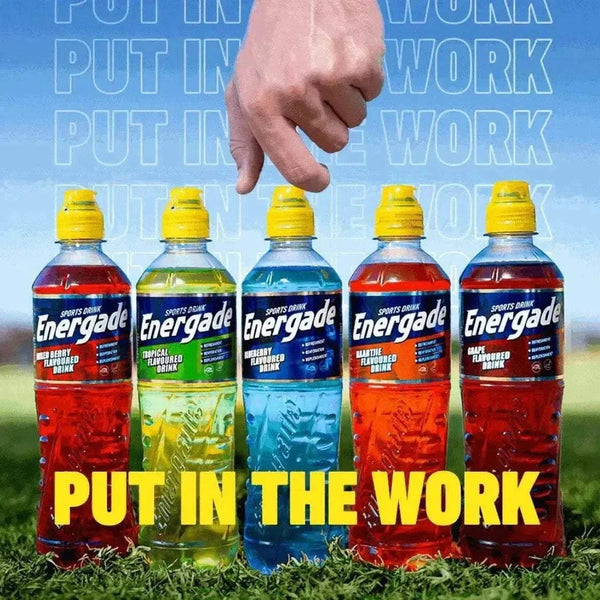 Energade sports drinks lineup with five bottles, including blueberry flavor, outdoors.