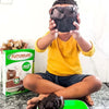 Futurelife Cereal (Chocolate) - 500g package next to a child holding a chocolatey treat.