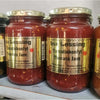 Ina Lessing Tomato Jam jars on a shelf, showcasing a handcrafted, all-natural condiment made with fresh tomatoes and spices, available in 500g size.