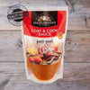Ina Paarman Peri-Peri Coat & Cook Sauce 200ml pouch on wooden background.