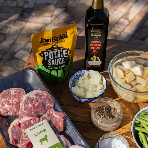 Jan Braai Sauces Classic Lamb Potjie Sauce 400g with lamb meat, chopped onions, potatoes, green beans, black pepper, salt, and extra virgin olive oil ingredients for potjie cooking