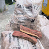 Camel Thorn Firewood bags stacked, showcasing dense, high-quality wood ideal for efficient, low-smoke burning in fireplaces and outdoor cooking.