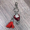 Red heart-shaped key tag with donkey, "Genade" text, and red tassel