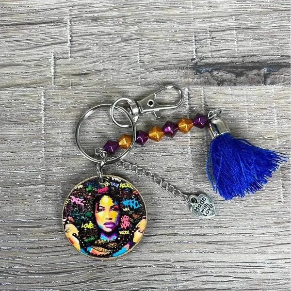 Wooden circular key tag with woman's face and navy tassel