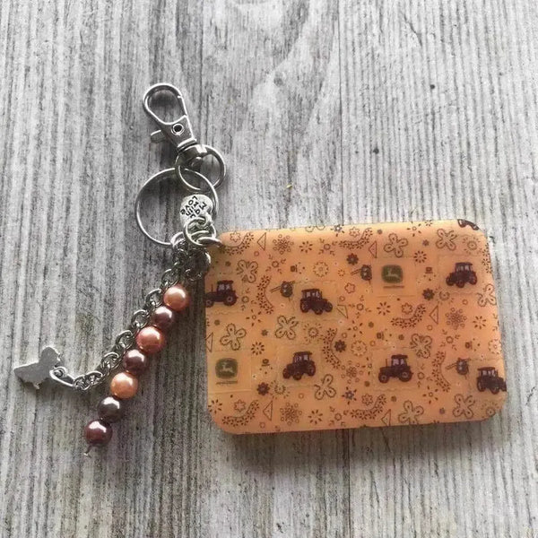 Keyring featuring a John Deere tractor design 65mm x 45mm