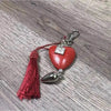 Red heart-shaped keyring with donkey and "Genade" text, 50mm size