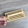 Medium gold plastic Koeksister cutter for traditional Afrikaans pastry dough shaping and braiding