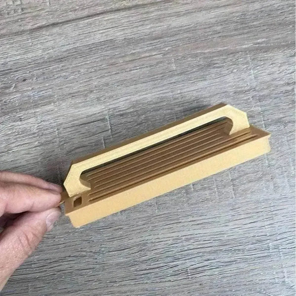 Medium gold plastic Koeksister cutter for shaping traditional Afrikaans dough into braided pastries