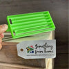 Green medium-sized plastic Koeksister cutter for making traditional braided Afrikaans dough pastries