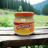 Melrose Cheese Spread Cheddar 250g jar with creamy cheddar cheese spread on wooden surface outdoors