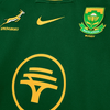 Close-up of 2025 Nike Springboks Home Stadium jersey in green with gold embroidered Springbok, Nike swoosh, and South Africa Rugby crest.