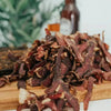 Close-up of sliced Original Biltong ready to eat on wooden board with blurred background