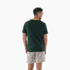 Man wearing 2XL Springbok Pajama Set with green short-sleeve top and white elastic waist shorts with Springbok logo pattern, back view