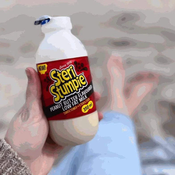 Steri Stumpie Peanut Butter Flavored Low Fat Milk 350ml bottle held outdoors.