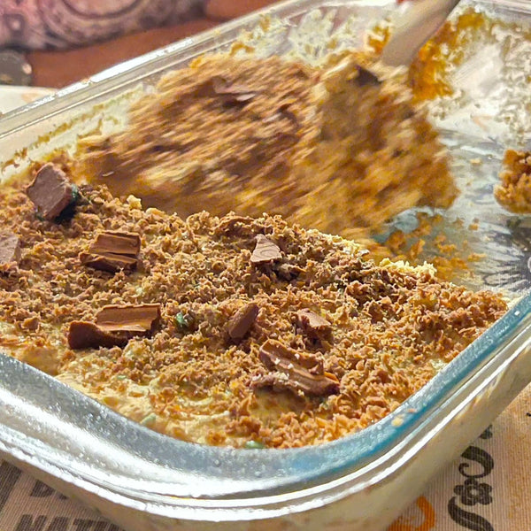 Peppermint Crisp Tart Cake made with Bakers Tennis Biscuits in a glass dish.