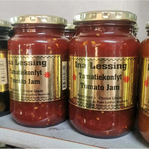 Ina Lessing Tomato Jam jars on a shelf, showcasing a handcrafted, all-natural condiment made with fresh tomatoes and spices, available in 500g size.