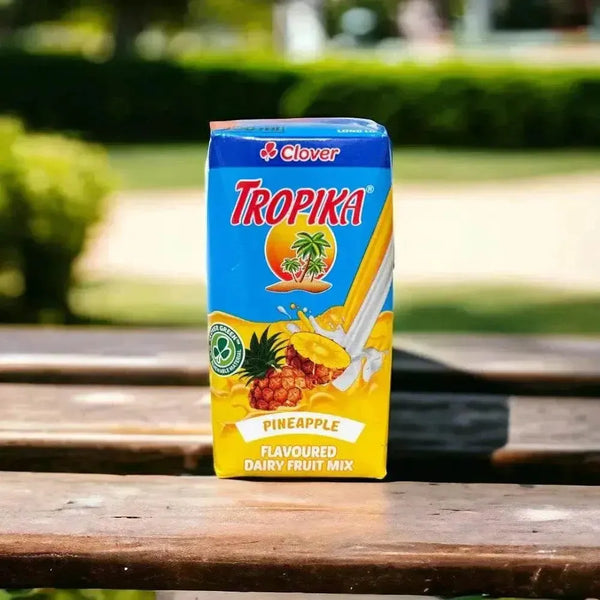 Tropika Pineapple Dairy Fruit Mix carton on an outdoor table