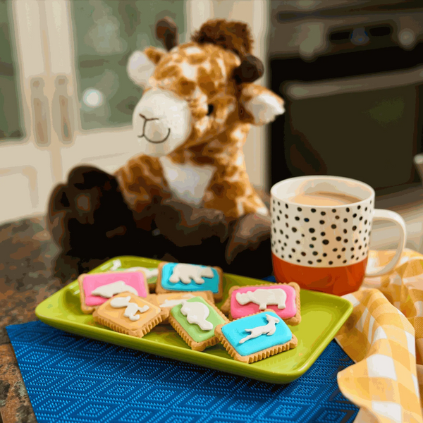 Bakers Zoo Biscuits with iced animal shapes on vibrant backgrounds, perfect for parties and celebrations.