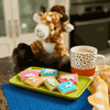 Pack of 12 Bakers Zoo Biscuits with colorful iced animal shapes on vibrant backgrounds