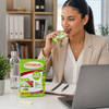 Office worker enjoying a Futurelife High Energy Choc Strawberry Crunch 40g bar with the 160g four-pack