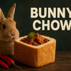High-quality photograph of traditional South African bunny chow food in a hollowed bread loaf with spicy curry filling