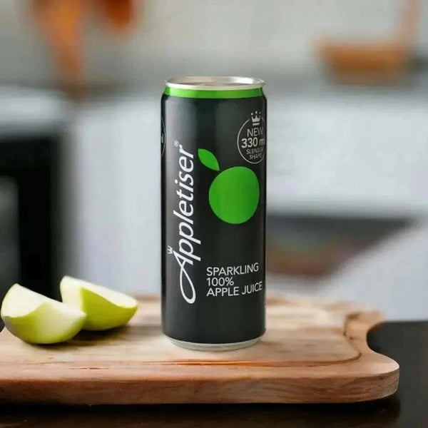 Appletiser 300ml can beside sliced green apple