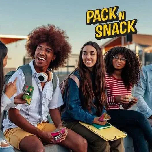 Group of friends enjoying Bakers Mini Cheddars with tangy fruit chutney flavor outdoors.