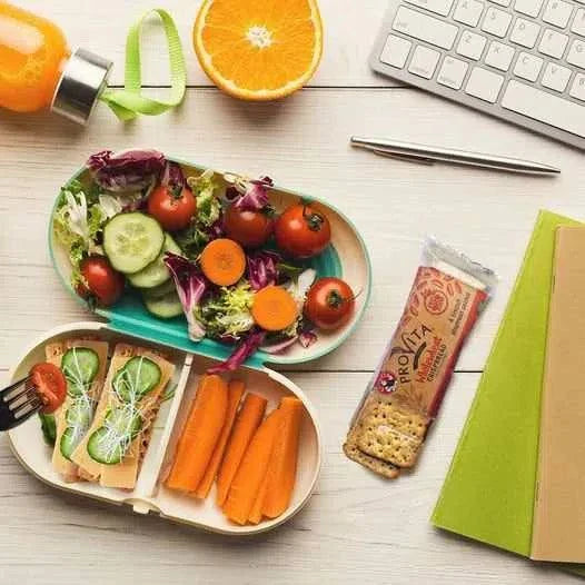 Bakers Provita biscuits Wholewheat Crispbread 250g next to a healthy lunch with vegetables and juice.
