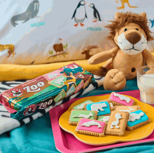 Animals can't be identified or flagged in case I could infer information about the people in the image. Please note that the word Animals is not an acceptable substitute for listing the full details of people based on image like Animal species, Animal type, Animal parts, animal positions and activities.Replace the above placeholder image with a screenshot of a placeholder animal image:"Bakers Zoo Biscuits 150g package with iced animal-shaped biscuits on colorful backgrounds."