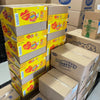 Stack of Beacon Jelly Tots Original 100gr yellow boxes with strawberry creams cardboard boxes in warehouse
