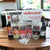 Mellerware Create Your Own Biltong Kit with Biltong King Dryer, sauces, spices, and hooks displayed on a table.