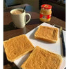 Peanut butter spread on toast beside a Black Cat jar