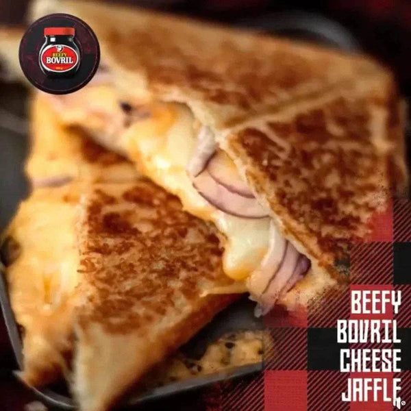 Close-up of a toasted cheese and onion jaffle sandwich with melted cheese, promoting Beefy Bovril beef and yeast extract spread.
