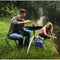 Outdoor cooking with CADAC Skottel Braai at a campsite.