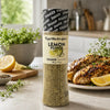 Cape Herb & Spice Lemon Pepper Shaker 290g beside grilled chicken and lemon in a bright kitchen