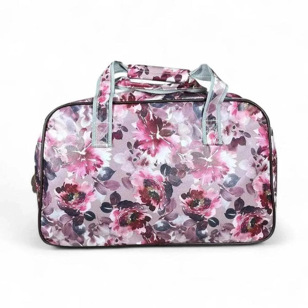 Light pink travel bag with purple rose pattern and multiple zippered pouches