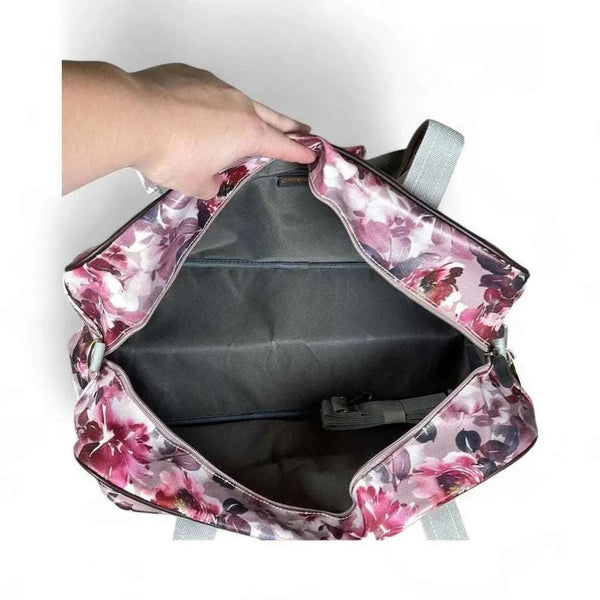 Open light pink travel bag with purple rose pattern showing large main compartment and small zipped front pouch