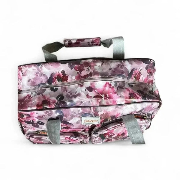 Light pink Cotton Road travel bag with purple roses and adjustable strap