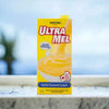 Danone Ultramel Custard 1 Litre packaging on marble surface.