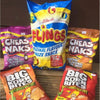 Willards Flings original flavour maize snack 150g bag with Cheas Naks and Big Korn Bites varieties on wooden surface