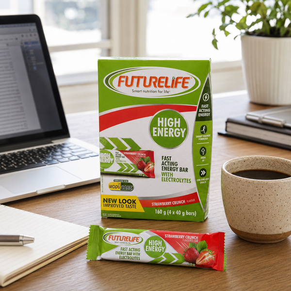 Futurelife High Energy Strawberry Crunch bars beside a laptop and coffee on a home-office desk