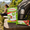 Futurelife High Energy Strawberry Crunch bars with a backpack and water bottle at an adult hiking rest stop